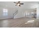 Bright, open-concept living area with light wood floors, a staircase, and plenty of natural light at 715 Rumbling Leaf Ln, Summerville, SC 29486
