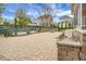 Beautifully landscaped backyard with a stone patio, a built-in fire pit, and lush green landscaping at 729 Quintan St, Summerville, SC 29486