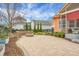 Charming backyard with a stone patio, a fire pit, and a view of the surrounding neighborhood at 729 Quintan St, Summerville, SC 29486