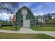 Beautifully designed and maintained barn with green siding, white trim, and ample grassy area at 729 Quintan St, Summerville, SC 29486