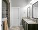 Bathroom featuring double sinks, framed mirrors, and a walk-in shower with decorative tile at 729 Quintan St, Summerville, SC 29486