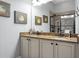 Bathroom with granite countertops, dual sinks, framed mirrors, and a glass enclosed tiled shower at 729 Quintan St, Summerville, SC 29486