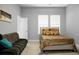 This bedroom features a couch, bed, and large window for ample lighting at 729 Quintan St, Summerville, SC 29486
