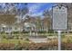 Community park with a historic marker in front of a water feature and neighborhood homes at 729 Quintan St, Summerville, SC 29486