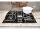 Close-up of a cooktop on a kitchen island with granite countertops and modern appliances at 729 Quintan St, Summerville, SC 29486
