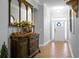 Bright foyer featuring wood floors and a decorative mirror, creating an inviting entrance at 729 Quintan St, Summerville, SC 29486