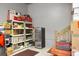 Functional garage space with ample storage shelving, mini refrigerator, and workbench areas at 729 Quintan St, Summerville, SC 29486