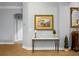 Inviting hallway with console table, stylish decorations, elegant painting, and hardwood flooring at 729 Quintan St, Summerville, SC 29486