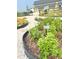 Aromatic herb garden featuring labelled plantings, gravel paths, and lush greenery at 729 Quintan St, Summerville, SC 29486