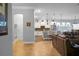 Open floor plan showcasing a kitchen with white cabinets, granite countertops, and stainless steel appliances at 729 Quintan St, Summerville, SC 29486