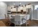 Modern kitchen with white cabinetry, a large center island with seating, and stainless steel appliances at 729 Quintan St, Summerville, SC 29486