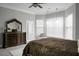This main bedroom features bay window, ample natural light, and crown molding at 729 Quintan St, Summerville, SC 29486