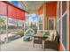 Inviting screened-in porch with comfortable seating, colorful pillows, and a view of the backyard at 729 Quintan St, Summerville, SC 29486