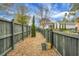 This property features a large side yard with a mulch path, wooden fence, and small evergreens at 729 Quintan St, Summerville, SC 29486