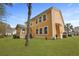 Backyard featuring a yellow home, grass, and a tree at 8592 Sentry Cir, North Charleston, SC 29420