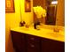 Bright bathroom featuring double sinks, wooden cabinets, and a separate glass shower at 8592 Sentry Cir, North Charleston, SC 29420