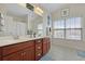 Bathroom featuring double vanity sinks, large mirror, and tile floors at 8592 Sentry Cir, North Charleston, SC 29420