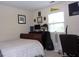 Bedroom with bed, desk and computer, guitar, and window with natural light at 8592 Sentry Cir, North Charleston, SC 29420