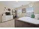Bright bedroom with large windows and decor, featuring a dresser, desk and chair at 8592 Sentry Cir, North Charleston, SC 29420