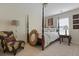 Bright bedroom featuring a four-poster bed, unique mirror, and decorative chair at 8592 Sentry Cir, North Charleston, SC 29420