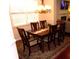 Elegant dining room with dark wood table, chandelier, and large window at 8592 Sentry Cir, North Charleston, SC 29420