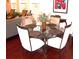 Bright breakfast nook featuring a glass-top table and comfortable white chairs at 8592 Sentry Cir, North Charleston, SC 29420