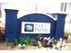 Community sign featuring Indigo Palms entrance with brick facade and manicured landscaping at 8592 Sentry Cir, North Charleston, SC 29420