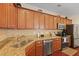 Modern kitchen featuring stainless steel appliances, granite countertops, and ample cabinet space at 8592 Sentry Cir, North Charleston, SC 29420