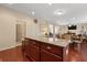 Open-concept kitchen showcasing a granite countertop island with seating and seamless transition to living areas at 8592 Sentry Cir, North Charleston, SC 29420