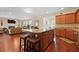 Spacious kitchen island featuring seating and granite countertops, seamlessly flowing into the living area at 8592 Sentry Cir, North Charleston, SC 29420