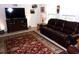 Cozy living room with plush leather seating, large rug, and home entertainment system at 8592 Sentry Cir, North Charleston, SC 29420