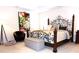 Spacious bedroom with ornamental iron bed, sitting area, and lots of natural light at 8592 Sentry Cir, North Charleston, SC 29420