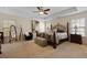 Spacious main bedroom featuring a tray ceiling, decorative bed frame, and ample natural light at 8592 Sentry Cir, North Charleston, SC 29420