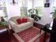 The light-filled sun room with hardwood floors is decorated with plants at 8592 Sentry Cir, North Charleston, SC 29420