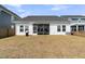 The home's backyard features a covered patio, grilling area, and well-manicured lawn at 87 Morning Song St, Summerville, SC 29485