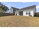 Spacious backyard with a screened-in porch perfect for outdoor entertaining and relaxation at 87 Morning Song St, Summerville, SC 29485