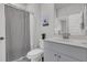 Bright bathroom with white vanity, modern fixtures, and a stylish black and white striped shower curtain at 87 Morning Song St, Summerville, SC 29485