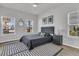 Comfortable bedroom with a gray bed, natural light, and stylish decorations at 87 Morning Song St, Summerville, SC 29485