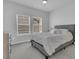 Bedroom with gray carpet, queen bed, a bedside table, and lots of natural light at 87 Morning Song St, Summerville, SC 29485