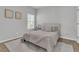 Relaxing bedroom with a white bed, soft linens, and natural lighting at 87 Morning Song St, Summerville, SC 29485