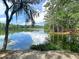 The community lake is surrounded by trees and greenery, offering a peaceful place to relax at 87 Morning Song St, Summerville, SC 29485