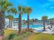Community pool with palm trees and lounge seating offers a great place to relax and socialize at 87 Morning Song St, Summerville, SC 29485