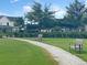 Manicured community walkway with green grass and lush shrubbery runs through beautiful homes at 87 Morning Song St, Summerville, SC 29485