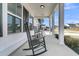 Inviting covered front porch with classic rocking chairs and stylish exterior finishes at 87 Morning Song St, Summerville, SC 29485
