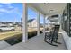 Comfortable front porch view with rocking chairs and serene neighborhood scenery at 87 Morning Song St, Summerville, SC 29485