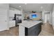 Spacious kitchen with quartz countertops, stainless steel appliances, and seamless flow to living area at 87 Morning Song St, Summerville, SC 29485