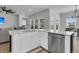 Open kitchen with quartz counters, stainless steel appliances, eat-in dining and living area at 87 Morning Song St, Summerville, SC 29485