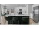 Spacious kitchen island featuring quartz countertops, stainless steel appliances, white cabinetry and eat-in seating at 87 Morning Song St, Summerville, SC 29485