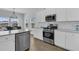 Well-lit kitchen featuring stainless steel appliances, white cabinets and eat-in kitchen at 87 Morning Song St, Summerville, SC 29485