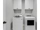 Functional laundry room featuring a new washer and dryer and white cabinets for storage at 87 Morning Song St, Summerville, SC 29485